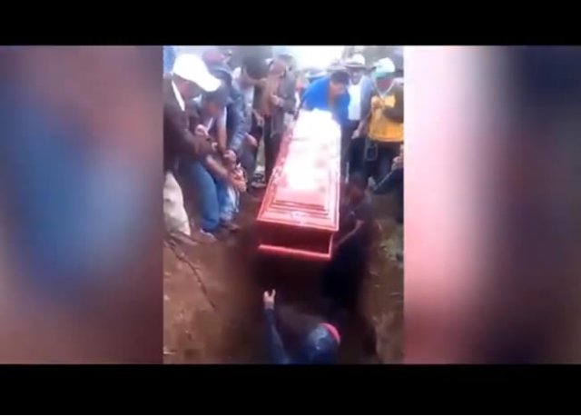 Woman's body falls out of coffin during burial