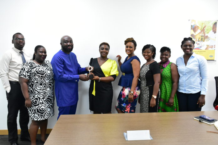 MTN Ghana Corporate Communications team and reps of Touchpoint Magna Carta in a pose with the award MTN