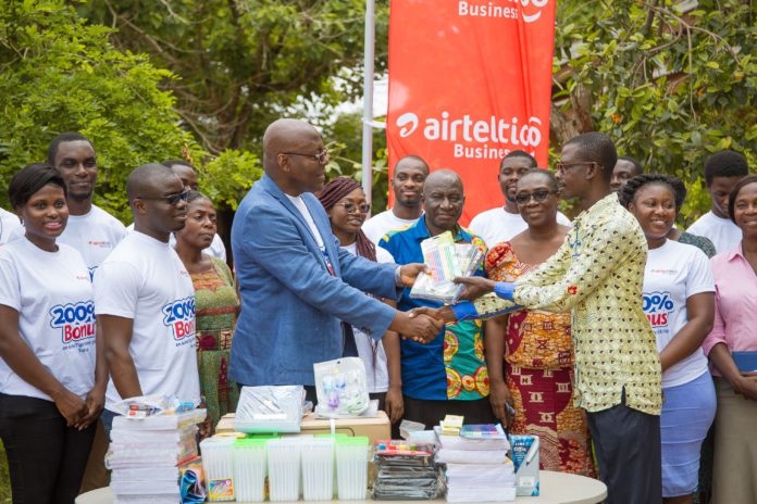 Chief HR Officer at AirtelTigo Eric Adadevoh presenting items to the the Circuit Supervisor for La Wireless Cluster of School airtel tigo