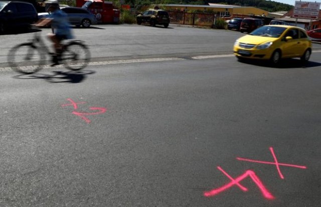 Police markings on the road where the bullets had been fired Police markings on the road where the bullets had been fired