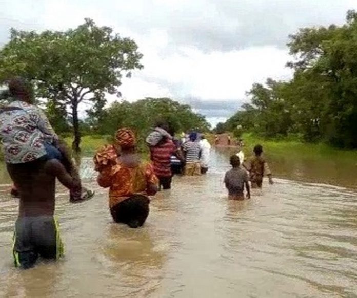 Some-members-of-the-community-wading-through-the-water-to-their-homes (Copy)