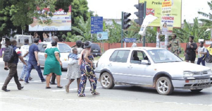 Pedestrains crossing the road in front of the 37 Military Hospital in Accra Pedestrains crossing the road in front of the 37 Military Hospital in Accra