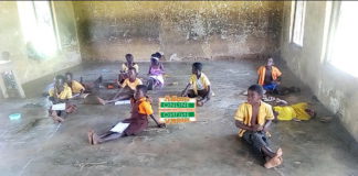classroom pupils sit on bare floor