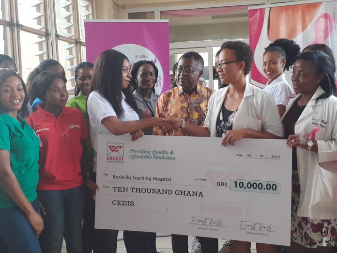 Prof. Clegg Lamptey (middle), look on as check is presented