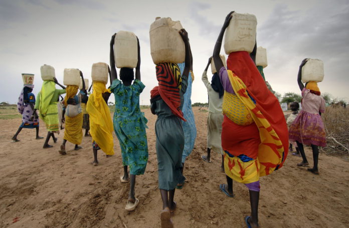 Women carrying water collected from taps