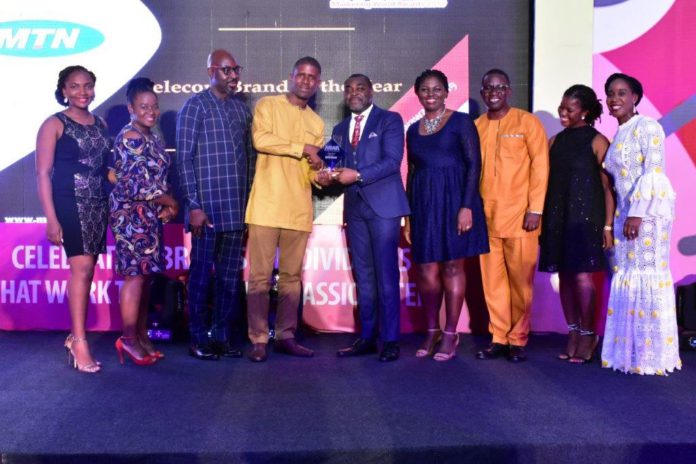 Germain Naatey, Media Planning Manager receiving Telecom Brand of the Year Award on behalf of MTN