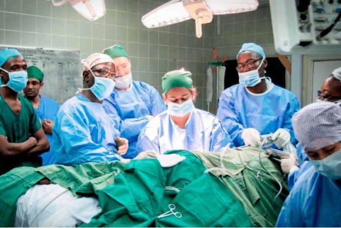 The medical team doing a kidney transplant on one of the patients The medical team doing a kidney transplant on one of the patients