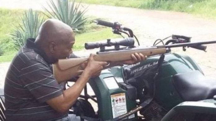 South Africa's Jacob Zuma takes aim in rifle photo South Africa's Jacob Zuma takes aim in rifle photo