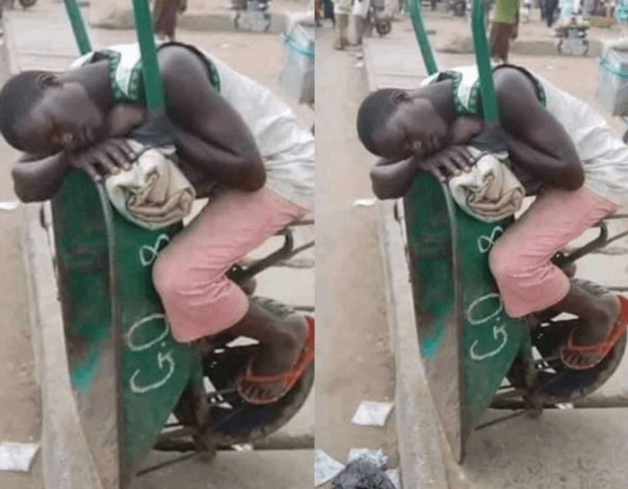 Man sleeping on a wheelbarrow Man sleeping on a wheelbarrow
