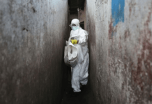 Uganda announces lockdown as Ebola cases rise PHOTO: A Red Cross burial team wore protective clothing to visit houses where people were infected with Ebola. (Getty Images: John Moore)