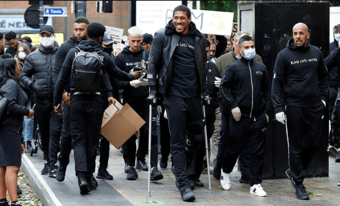 Anthony Joshua hobbles on crutches as he joins Black Lives Matter protest Anthony Joshua hobbles on crutches as he joins Black Lives Matter protest