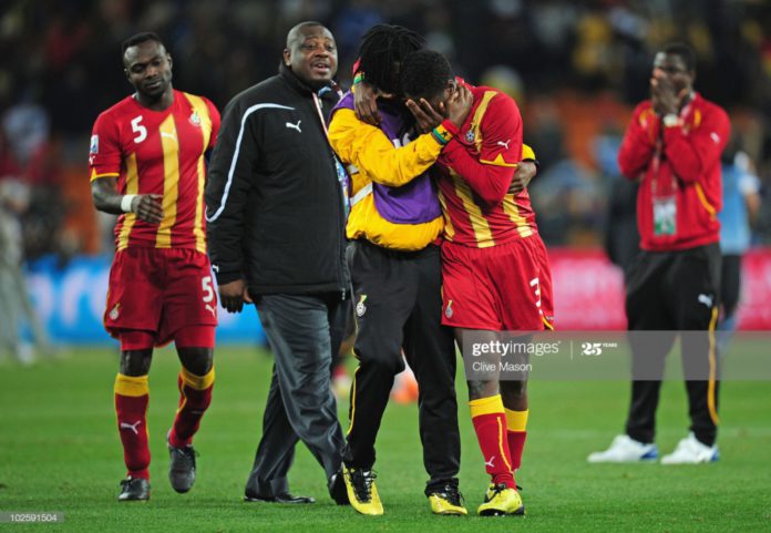 JOHANNESBURG, SOUTH AFRICA – JULY 02: Asamoah Gyan is consoled by Derek Boateng after Ghana are knocked out in a penalty shoot-out during the 2010 FIFA World Cup South Africa Quarter Final match between Uruguay and Ghana at the Soccer City stadium on July 2, 2010, in Johannesburg, South Africa. (Photo by Clive Mason/Getty Images) JOHANNESBURG, SOUTH AFRICA – JULY 02: Asamoah Gyan is consoled by Derek Boateng after Ghana are knocked out in a penalty shoot-out during the 2010 FIFA World Cup South Africa Quarter Final match between Uruguay and Ghana at the Soccer City stadium on July 2, 2010, in Johannesburg, South Africa. (Photo by Clive Mason/Getty Images)