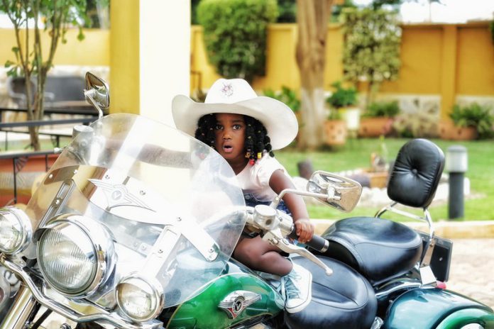 Gifty Anti's daughter, Nyame Anuonyam poses on father's motorbike Gifty Anti's daughter, Nyame Anuonyam poses on father's motorbike