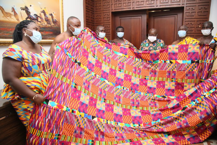 2. President Nana Addo Dankwa Akufo-Addo being presented with a Kente cloth by the Royal Kente Weavers Asociation after a meeting at the Jubilee House. Kente Village