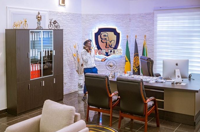 Shatta Wale makes a call in his personal "Shatta Movement" office /Photo Credit: @kwabenaawuku Shatta Wale makes a call in his personal "Shatta Movement" office /Photo Credit: @kwabenaawuku