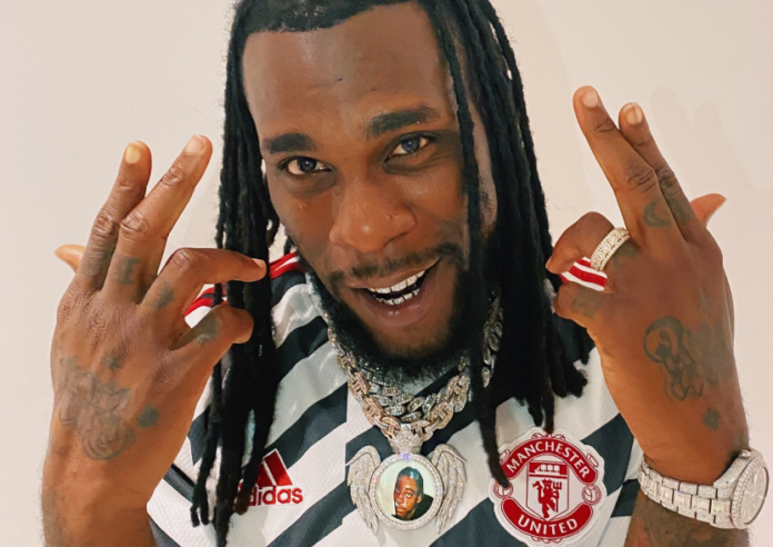 Burna Boy wears new Manchester United football jersey Burna Boy wears new Manchester United football jersey