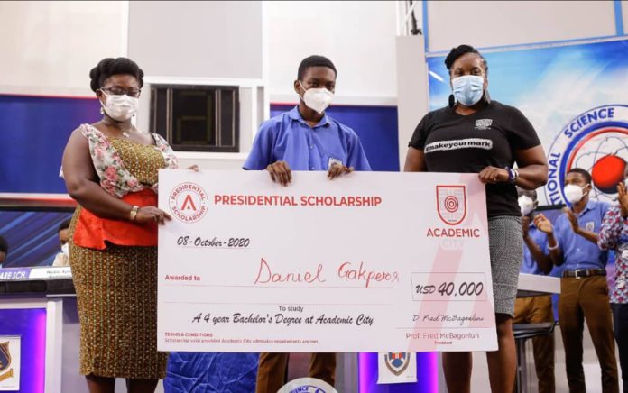 Dr. Lucy Agyepong (right) and Ms. Shannan Akosua Magee of Academic City presenting the scholarship to Mr. Daniel Kekeli Gakpetor (middle) Dr. Lucy Agyepong (right) and Ms. Shannan Akosua Magee of Academic City presenting the scholarship to Mr. Daniel Kekeli Gakpetor (middle)