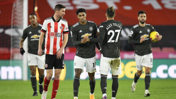 Marcus Rashford of Manchester United celebrates with team mate Alex Telles after scoring their sides first goal during the Premier League match between Sheffield United and Manchester United at Bramall Lane Image credit: Getty Images Marcus Rashford of Manchester United celebrates with team mate Alex Telles after scoring their sides first goal during the Premier League match between Sheffield United and Manchester United at Bramall Lane Image credit: Getty Images