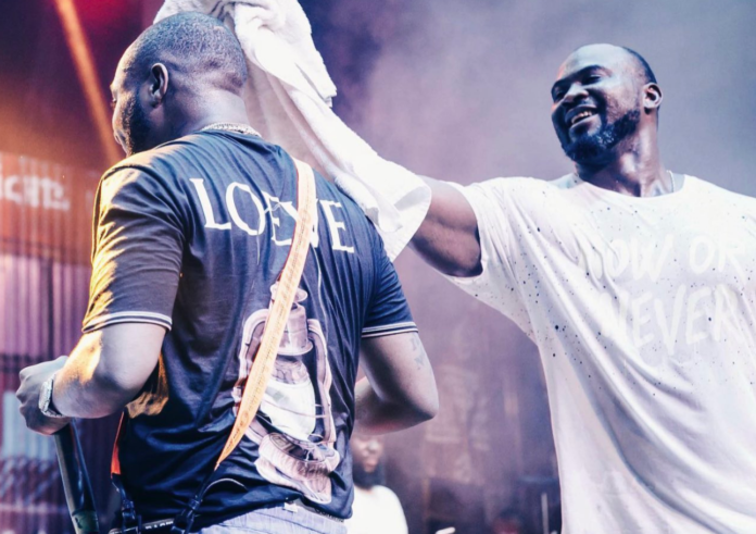 Davido's fallen bodyguard TJ wipes sweat off the musician during performance