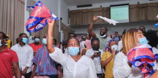 Lydia Alhassan waves an NPP flag to signify victory after she floored John Dumelo at Ayawaso West Wuogon
