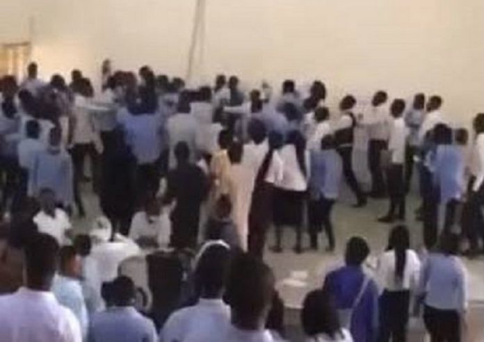 Embattled lecturer surrounded by angry students Embattled lecturer surrounded by angry students