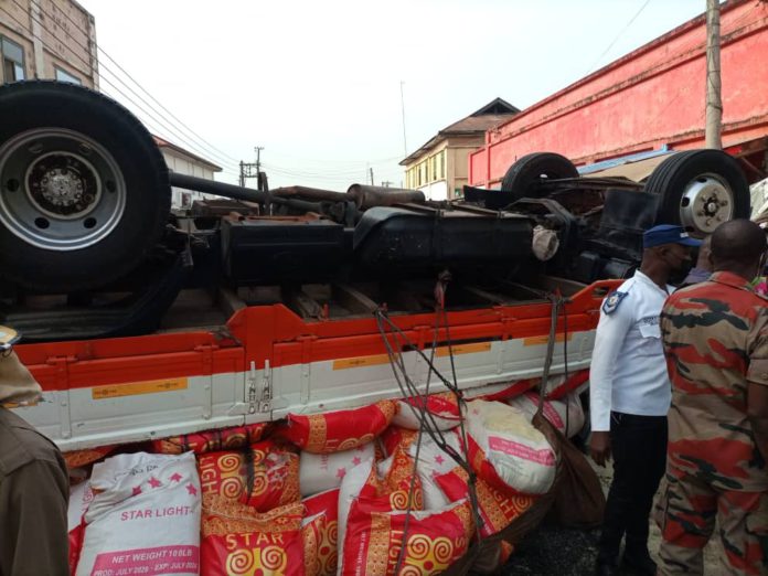 Two injured after truck rams into six cars, shop