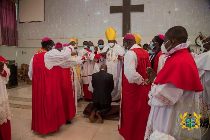 pastors surround Akufo-Addo as he kneels down for prayers pastors surround Akufo-Addo as he kneels down for prayers