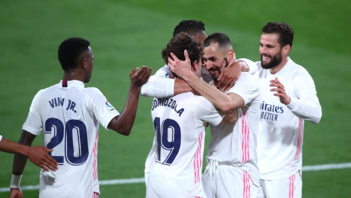 Alvaro Odriozola of Real Madrid celebrates with Karim Benzema after scoring their side's second goal during the La Liga Santander match between Cadiz CF and Real Madrid at Estadio Ramon de Carranza on April 21, 2021 in Cadiz, Spain Image credit: Getty Images Alvaro Odriozola of Real Madrid celebrates with Karim Benzema after scoring their side's second goal during the La Liga Santander match between Cadiz CF and Real Madrid at Estadio Ramon de Carranza on April 21, 2021 in Cadiz, Spain Image credit: Getty Images