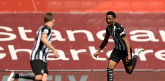 Joe Willock of Newcastle United celebrates after scoring their side's first goal during the Premier League match between Liverpool and Newcastle United at Anfield Image credit: Getty Images