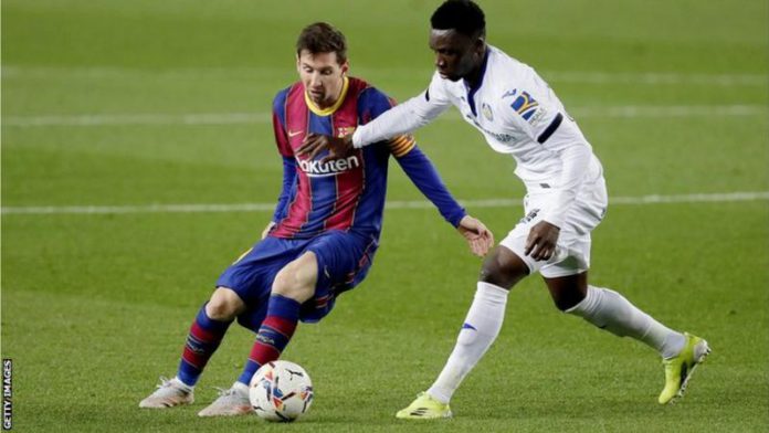 Getafe's Ghanaian midfielder Sabit Abdulai (right) tries to tackle Barcelona's Lionel Messi Getafe's Ghanaian midfielder Sabit Abdulai (right) tries to tackle Barcelona's Lionel Messi