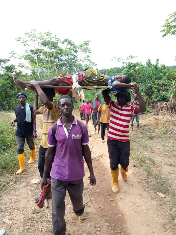 Pregnant woman being carried on wooden door