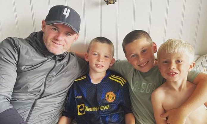 Wayne Rooney poses proudly with his three eldest sons