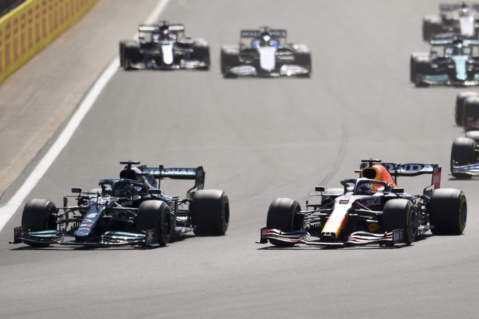 British Formula One driver Lewis Hamilton (front - L) of Mercedes-AMG Petronas and Dutch Formula One driver Max Verstappen (front - R) of Red Bull Racing in action during the Formula One Grand Prix of Great Britain at the Silverstone Circuit, in Northamptonshire, Britain, 18 July 2021. EPA/ANDY RAIN Formula One Grand Prix of Great Britain