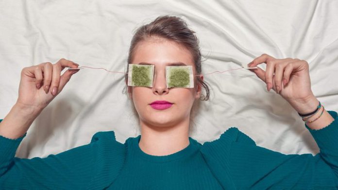 Young-Woman-with-tea-bags-on-her-eyes-