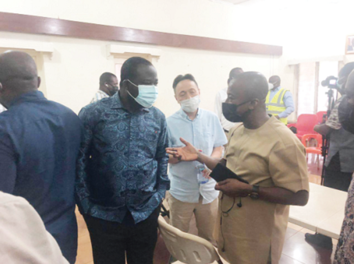 Mr Isaac Ofori-Poku (right ), Board Chairman of the GBC, having a discussion with Mr Alfred Obeng-Boateng (left), the MP for the area, and Mr J.K. Fang, the General Manager of the GBC, after the crisis meeting