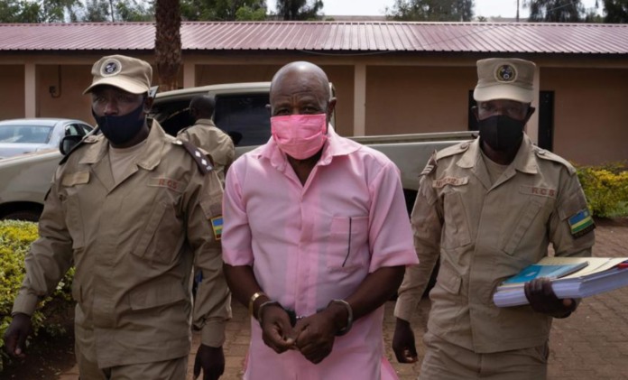"Hotel Rwanda" hero Paul Rusesabagina in the pink inmate's uniform arrives from the Nyarugenge prison with Rwanda Correctional Service (RCS) officers at the Nyarugenge Court of Justice in Kigali, Rwanda, on September 25, 2020