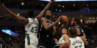 Reigning champions Milwaukee Bucks started their title defence with victory over Brooklyn Nets