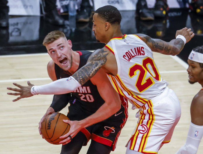 Miami Heat forward Micah Potter (L) in action against Atlanta Hawks forward John Collins (R) during the first half of the preseason NBA basketball game between the Miami Heat and the Atlanta Hawks at State Farm Arena in Atlanta, Georgia, USA, 14 October 2021. EPA/ERIK S. LESSER SHUTTERSTOCK OUT Miami Heat forward Micah Potter (L) in action against Atlanta Hawks forward John Collins (R) during the first half of the preseason NBA basketball game between the Miami Heat and the Atlanta Hawks at State Farm Arena in Atlanta, Georgia, USA, 14 October 2021. EPA/ERIK S. LESSER SHUTTERSTOCK OUT