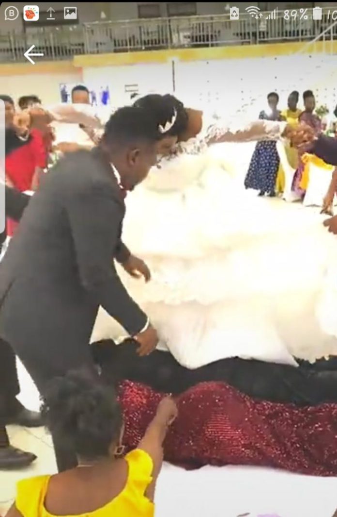 Couple walk on the back of their guests at wedding reception