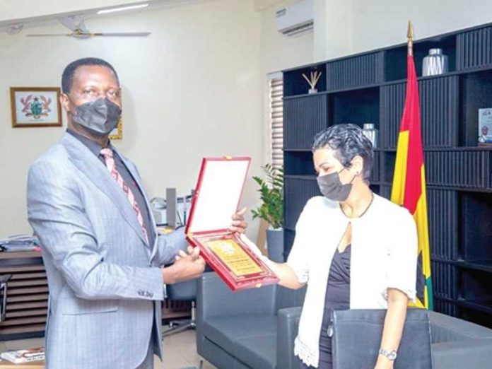 Dr Yaw Osei Adutwum, Education Minister, making a presentation to Mrs Anette Chao Garcia, the Cuban Ambassador to Ghana
