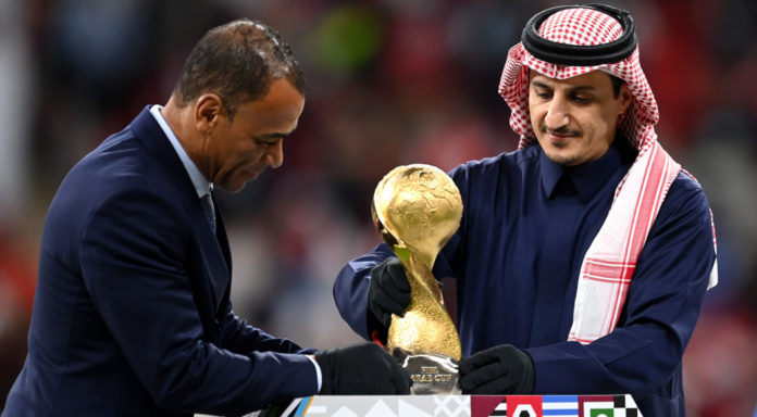 AL KHOR, QATAR - DECEMBER 18: Former Saudi Arabian International Player, Nawaf Al-Temyat (R) and Former Brazilian World Cup Winner, Cafu (L) place the FIFA Arab Cup Trophy on a plinth on pitch following the FIFA Arab Cup Qatar 2021 Final match between Tunisia and Algeria at Al Bayt Stadium on December 18, 2021 in Al Khor, Qatar. (Photo by Michael Regan - FIFA/FIFA via Getty Images) AL KHOR, QATAR - DECEMBER 18: Former Saudi Arabian International Player, Nawaf Al-Temyat (R) and Former Brazilian World Cup Winner, Cafu (L) place the FIFA Arab Cup Trophy on a plinth on pitch following the FIFA Arab Cup Qatar 2021 Final match between Tunisia and Algeria at Al Bayt Stadium on December 18, 2021 in Al Khor, Qatar. (Photo by Michael Regan - FIFA/FIFA via Getty Images)