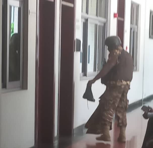 A prison officer holding the boots of the injured colleague A prison officer holding the boots of the injured colleague