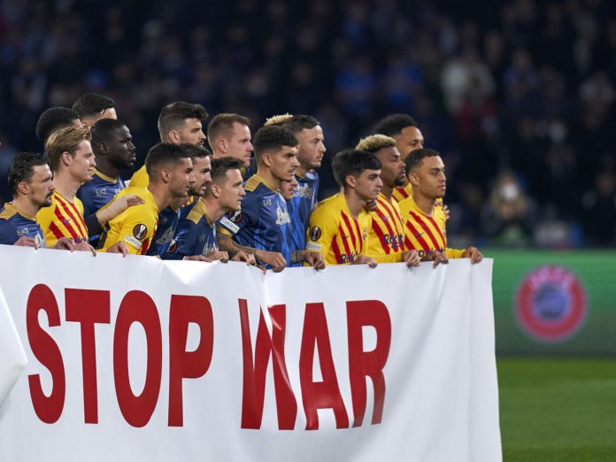 Barcelona and Napoli players hold banner Barcelona and Napoli players hold banner