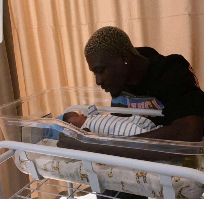 RJZ cradling his baby Source: RJZ/Instagram