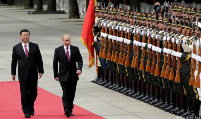 Putin joined Xi to review a military honor guard before talks in Beijing's grandiose Great Hall of the People. | Credit: Reuters