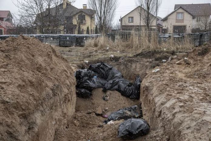 Bodies of civilians are seen in mass graves in Bucha ( Image: Anadolu Agency via Getty Images) Bodies of civilians are seen in mass graves in Bucha ( Image: Anadolu Agency via Getty Images)