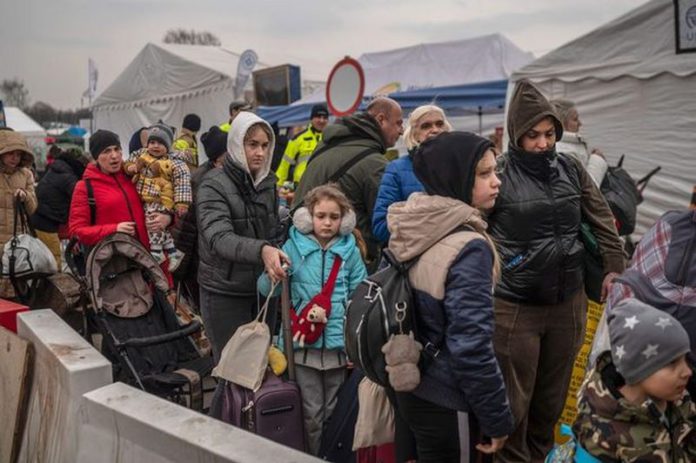 Ukrainian evacuees queue as they wait for further transport at the Medyka border crossing after they crossed the Ukrainian-Polish border ( Image: AFP via Getty Images) Ukrainian evacuees queue as they wait for further transport at the Medyka border crossing after they crossed the Ukrainian-Polish border ( Image: AFP via Getty Images)