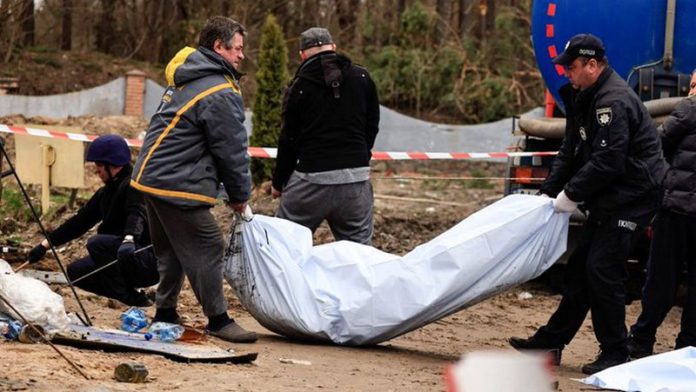 Police members carry the body of a civilian, after they exhumed him along with another body from a well at the fuel station in Buzova (Image: REUTERS) Police members carry the body of a civilian, after they exhumed him along with another body from a well at the fuel station in Buzova (Image: REUTERS)