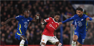 Manchester United's Fred (C) in action against Chelsea players Trevoh Chalobah (L) and Ruben Loftus-Cheek (R)