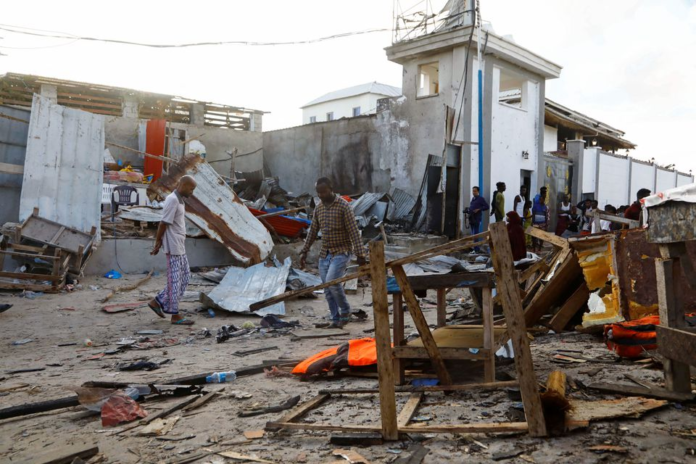 Bystanders walk through the scene of bombing at a seaside restaurant at Liido beach in Mogadishu, Somalia April 23, 2022. REUTERS/Feisal Omar Bystanders walk through the scene of bombing at a seaside restaurant at Liido beach in Mogadishu, Somalia April 23, 2022. REUTERS/Feisal Omar